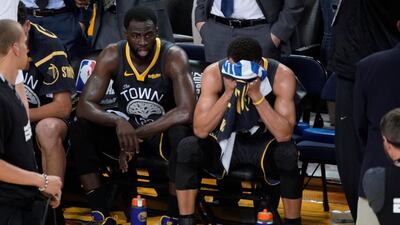 Golden State Warriors forward Draymond Green, left, sits on the bench next to guard Stephen Curry. AP Photo