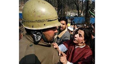 A Kashmiri Muslim woman argues with an Indian policeman during a protest over the killing of a 16-year-old student in Srinagar, one of about 100,000 people killed since the start of the insurgency in 1989.