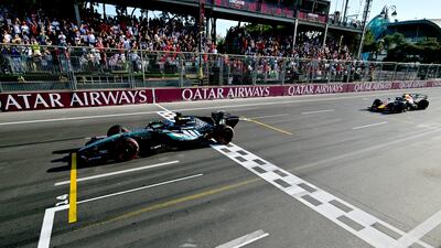 Mercedes driver George Russell crosses the finish line just ahead of Max Verstappen's Red Bull. EPA