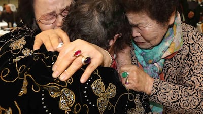 North Korean Kim Tae Un 78, centre, and her South Korean sisters Kim Sa-bun, left, and Kim Young-sun cry as they hug each other during a renion at the Mount Kumgang resort in North Korea on February 23, 2014. A group of South Koreans on Sunday crossed the world's most heavily fortified border, a frontier that separates two countries that remain at war after their conflict ended in an armistice rather than a peace treaty. Lee Ji-eun/Yonhap / Reuters