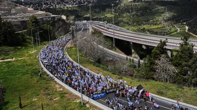 Israelis march on a highway towards Jerusalem to protest Prime Minister Benjamin Netanyahu's plans to dismiss the head of the Shin Bet internal security service. AP
