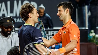 Novak Djokovic and Casper Ruud greet each other at the net following their Italian Open semi-final. EPA
