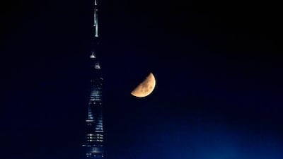 People who live on the upper floors of the Burj Khalifa must wait a little longer to break their fast because it takes them longer to see the sun set. Jeff Topping / The National