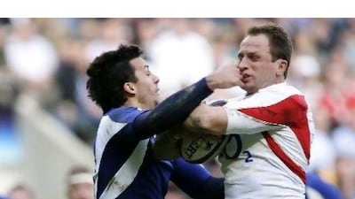 England's Mike Catt, right, and France's Clement Pointrenaud, do battle at Twickenham in 2007.