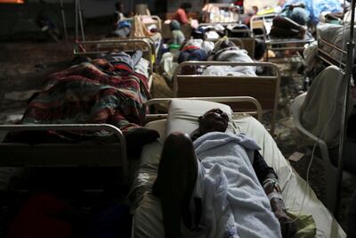 People injured in an earthquake that hit northern Haiti late on Saturday, sleep in a tent in Port-de-Paix, Haiti. Reuters