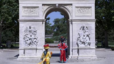 Two Chinese wearing traditional royal family costumes walking towards a mini replica of the Arc de Triomphe in Beijing World Park, in suburb Beijing. Beijing World Park, with a collection of mini replicas of famous architectures from all over the world, attempts to give visitors a chance to see the world without having to leave the capital.