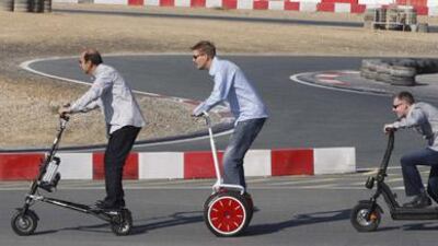 And they're off: (from left) Nicholas Mobayed on a Trikke, Bob Boersen on a Segway and Gordon Torbet on a Tante Paula electric scooter, at the Dubai Kartdrome.