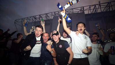 Leeds United fans celebrate outside Elland Road. PA