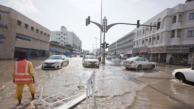 Motorists drive through flooded streets in Sharjah’s Industrial Area 1 last week. Municipality staff worked overtime to clean up most areas, especially at night when there was less traffic, and most roads were cleared successfully. Antonie Robertson / The National