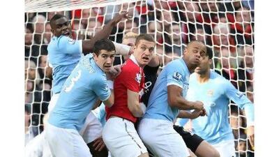 Alexsandar Kolarov, second left, Nemanja Vidic, centre and Vincent Kompany, right, will put friendship aside today. John Peters / Getty Images