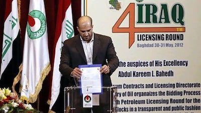 Ahmed Haider Ahmed, business development manager of Kuwait Energy, drops his offer in a box during the fourth licensing round for exploration blocks at the Iraq Oil Ministry's headquarters in Baghdad. Reuters