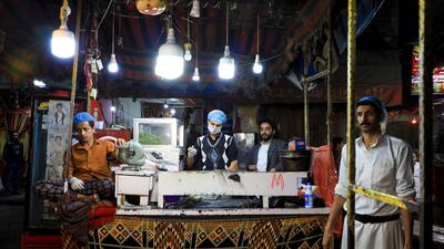 A cook stands at a kebab stall in the old city market of Yemen's capital Sanaa. AFP