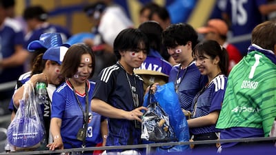 Japan fans have gained worldwide fame for their post-game cleanup ritual. AFP