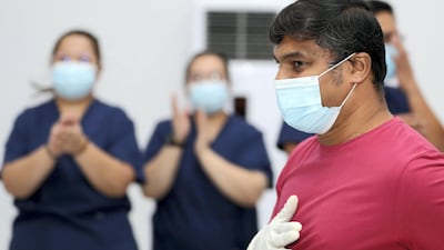 Medics cheer as the final 17 Covid-19 patients are discharged from Dubai Parks and Resorts field hospital. Chris Whiteoak / The National