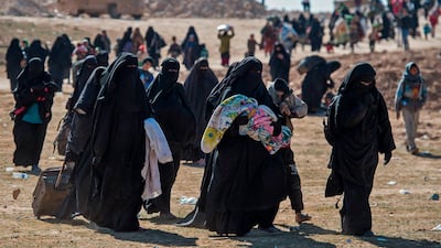 Fully veiled women and children fleeing from the Baghouz area in the eastern Syrian province of Deir Ezzor walk in a field during an operation by the US-backed Syrian Democratic Forces (SDF) to expel hundreds of Islamic State group (IS) members from the region. AFP