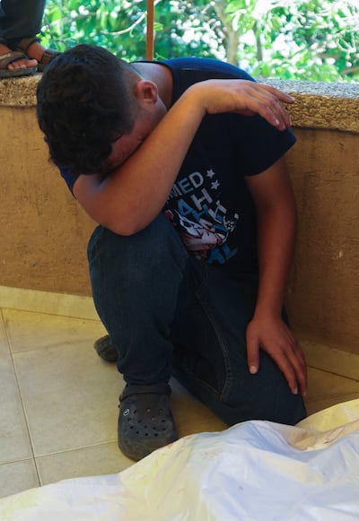 A Palestinian man mourns over a body at Nasser Hospital after a deadly Israeli strike on a police station in Khan Younis. Reuters