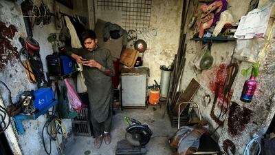A worker waits for electricity to be restored in Peshawar, north-west Pakistan. Energy Minister Mr Dastgir said it was 'not a major crisis'. EPA