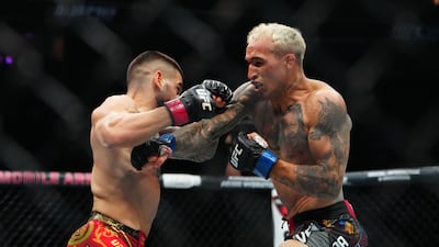 Ilia Topuria, left, fights Charles Oliveira. Imagn Images
