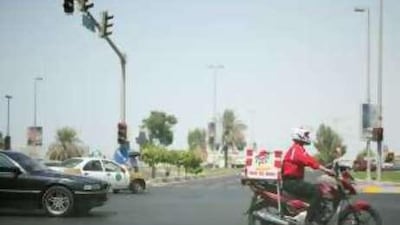 On the move - a restaurant delivery driver takes food to a customer.