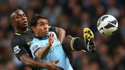 Maynor Figueroa, left, the Wigan defender, attempts to beat Manchester City's Carlos Tevez to the ball at Etihad Stadium. Alex Livesey / Getty Images