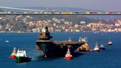 Then and now: above, the Varyag, as it was then known, passes the Bosporus bridge in Istanbul in November 2001 after being acquired by China from Ukraine.