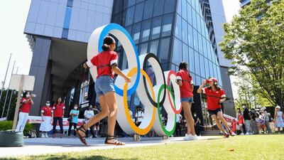 Visitors with the Olympic rings outside the Japan Olympic Museum in Tokyo.