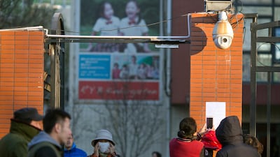 Parents take photos of a notice posted by the RYB kindergarten announcing measures taken in response to allegations of children abuse in Beijing on November 24, 2017. Ng Han Guan / AP Photo