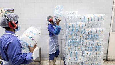With employees working in shifts around the clock, tube ice is produced under the brand name Pure Ice. It is of a relatively cylindrical shape with a hollow core and comes in an assortment of packaging sizes. The Dubai Investment Park factory alone produces a 120 tonnes of tube ice each day. Antonie Robertson / The National