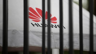 A Huawei logo is seen through the fence of its headquarters in Shenzhen, China. Reuters