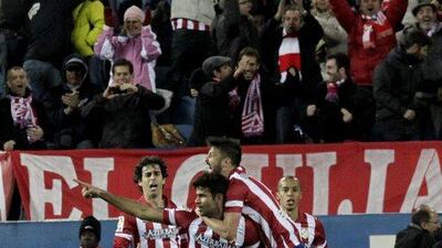 Atletico Madrid striker Diego Costa celebrates with teammates after scoring on Wednesday. Kiko Huesca / EPA / March 26, 2014