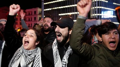 Anti-government protesters shout slogans, as they block a main road during ongoing protests against corruption and financial crisis, in Beirut, Lebanon. AP