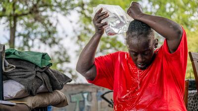 Andrea Washington pours water on herself in the Hungry Hill neighbourhood of Austin, Texas. Getty