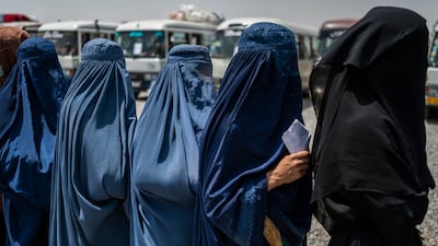 Internally displaced Afghan refugee women queue up at the UNHCR camp on the outskirts of Kabul to identify themselves and get money as they return home to the east, in July 2022. AFP