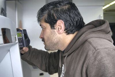 Abu Ahmad, 29, scans his iris at a branch of Cairo Amman Bank in the Jordanian capital Amman as a means of accessing UNHCR cash assistance. UNHCR