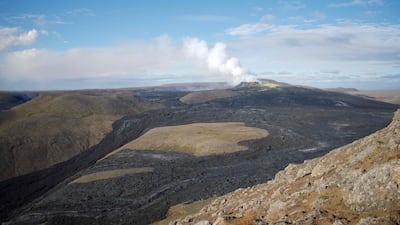 The plume from the active crater and part of the 4,6 square kilometre lava field are seen from a mountain near the eruption site in Fagradalsfjall, Iceland. The volcanic eruption near the capital Reykjavik is still going strong six months after lava began flowing. AFP