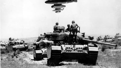 On the front lines of the 1967 war, a French-supplied Israeli bomber flies over a line-up of tanks. (AP Photo)