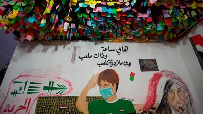 A mural representing an Iraqi pupil saying "this is a public square, and that is a schoolyard...we can play wherever you want", is seen under a canopy of sticky notes in Tahrir Square. AFP