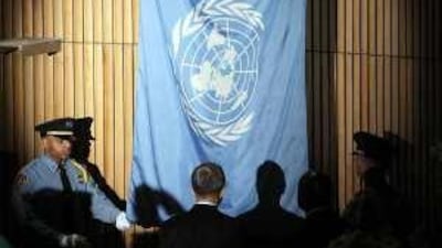 The United Nations secretary general Ban Ki-moon watches the UN flag being lowered at a memorial ceremony for the 101 agency staff who died in the earthquake in Haiti.