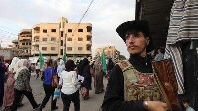 A member of the Syrian Democratic Forces stands guard as Kurds hold a protest in solidarity with the Druze minority. Reuters