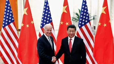 Chinese President Xi Jinping shakes hands with then-US vice president Joe Biden in Beijing on December 4, 2013. Reuters