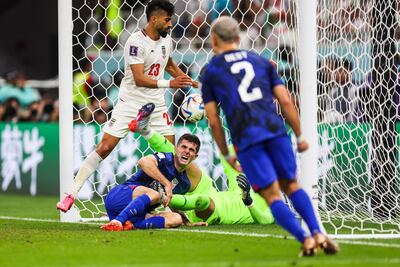 Christian Pulisic grimaces after colliding with Iran's goalkeeper to score what proved to be the matchwinner for USA. EPA