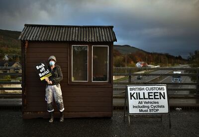 A Border Communities against Brexit protestor stands against a makeshift border customs hut as she takes part in a demonstration in Newry, Northern Ireland. Getty Images