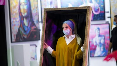 A real life 'Girl with a Pearl Earring' at the World Art Dubai. Leslie Pableo / The National