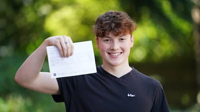 Ed Menlove, 18, poses with his grades at Peter Symonds College in Winchester.