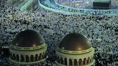 The new raised walkway installed around the Kabba so people with disabilities can circle around the holy shrine, as pilgrims perform evening prayers in Mecca's Grand Mosque. Fayez Nureldine / AFP