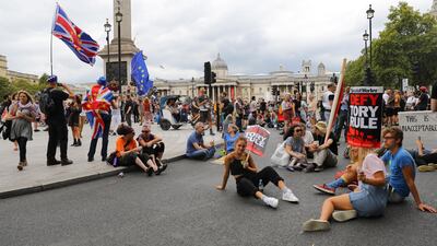 epa07807746 Anti Brexit protesters block the road and stop traffic in Trafalgar Square following a protest against Brexit and the prorogation of parliament in London, Britain, 31 August 2019. A number of 'Stop The Coup' protests are taking place across the Britain because the British government is to suspend Parliament after the summer break, a move that might block Members of Parliament from voting against a possible no-deal Brexit. EPA/VICKIE FLORES