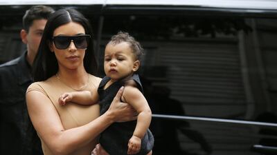 TV personality Kim Kardashian holds her daughter North in her arms as she shops in Paris on May 20, 2014. Kardashian and rapper Kanye West will celebrate their wedding in Florence on May 24, an official from the mayor’s office confirmed. Gonzalo Fuentes / Reuters