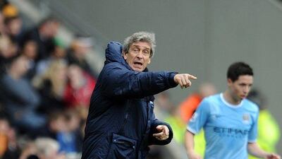 Manuel Pellegrini, left, manager of Manchester City gestures during the Premier League match between Hull City and Manchester City at the KC Stadium on March 15, 2014 in Hull, England. Clint Hughes/Getty Images