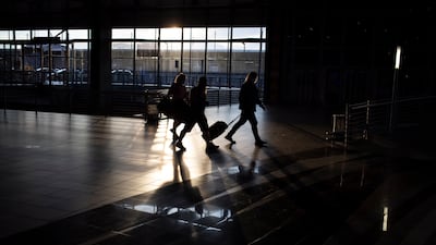 Passengers prepare to check in at a quiet OR Tambo International Airport. Many flights at the continent's busiest airport were cancelled amid the spread of the new variant. EPA