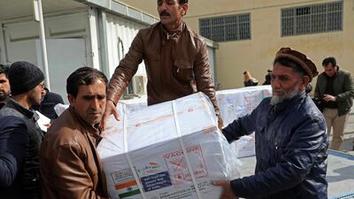 Afghan health ministry workers unload the first shipment of 500,000 doses of the Oxford-AstraZeneca coronavirus vaccine donated by the Indian government in Kabul. AP Photo.